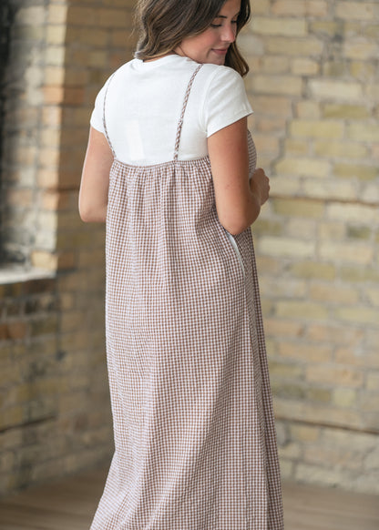 Back of the taupe gingham midi dress with adjustable straps and a gathered back neckline.