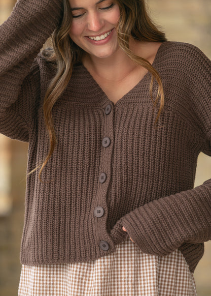 Close-up of the espresso knit cardigan featuring a V-neckline, ribbed texture, and button front.
