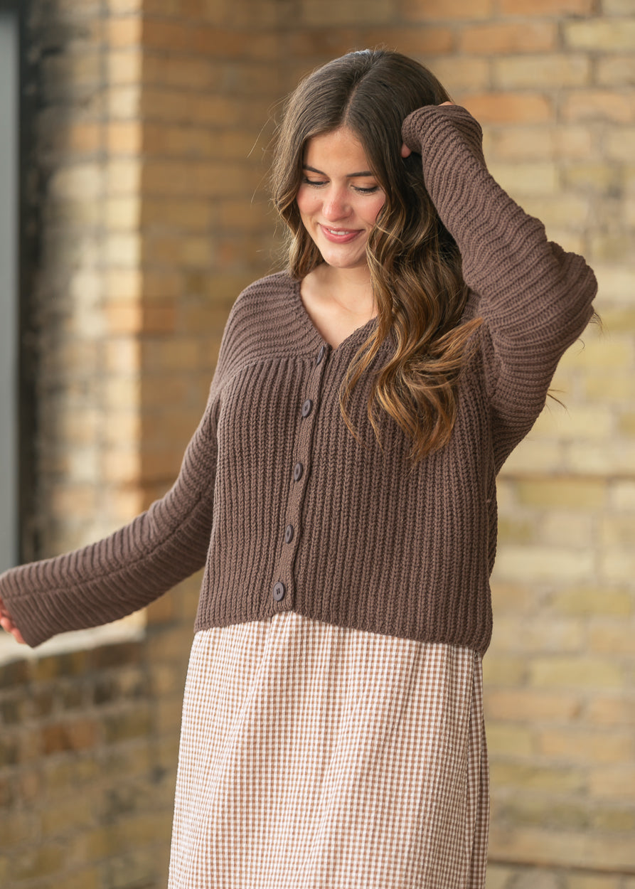 Relaxed fit espresso V-neck cardigan with ribbed knit sleeves and button front closure.