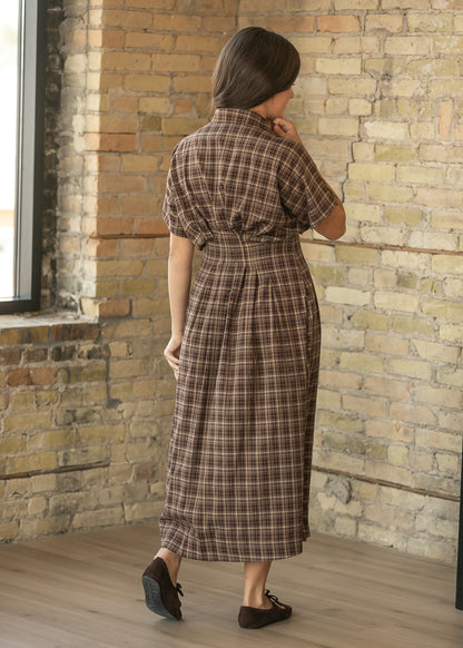 Back of brown plaid midi dress showing the defined waist, pleated A-line skirt, and short sleeves.
