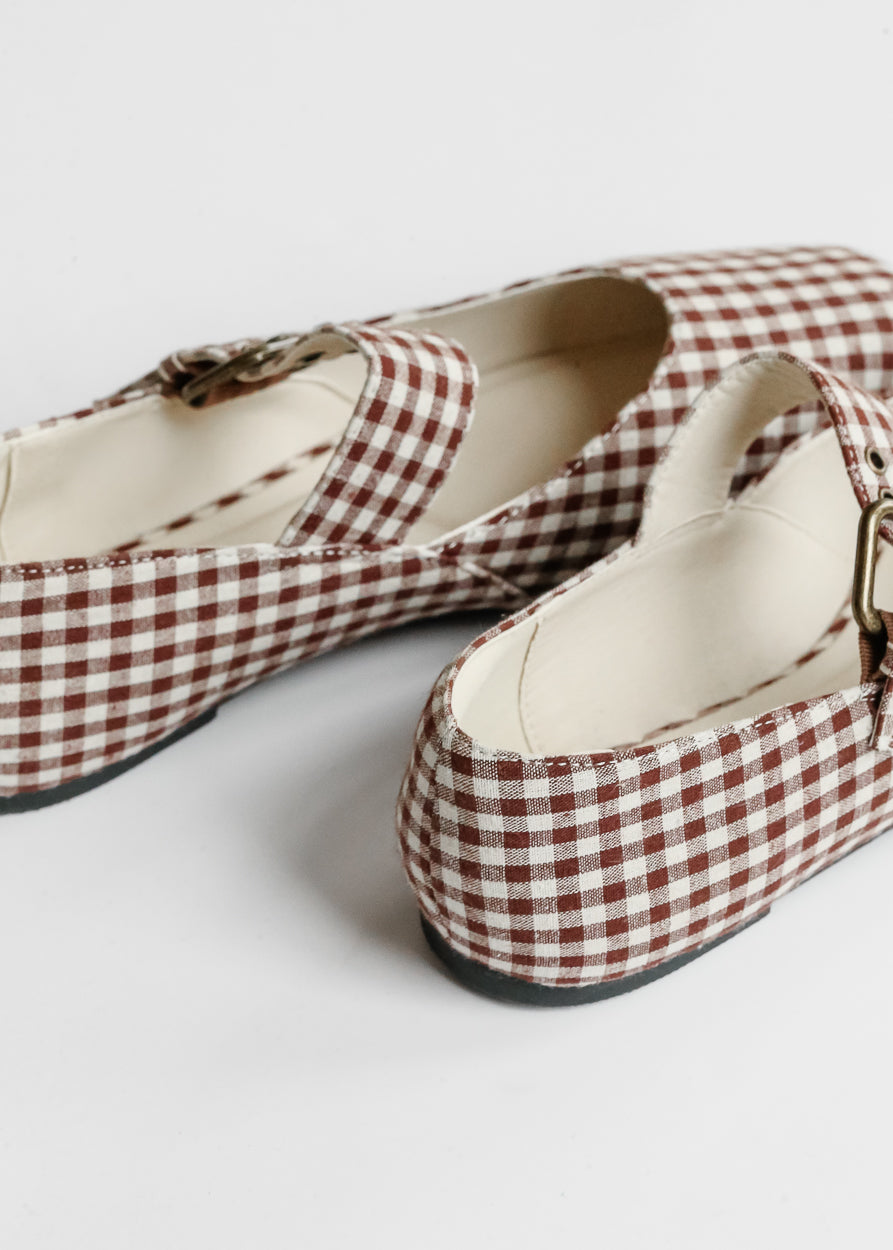 Rear detail of brown gingham ballet flats showing low heel and cream lining.
