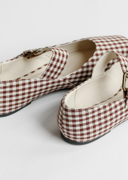 Rear detail of brown gingham ballet flats showing low heel and cream lining.