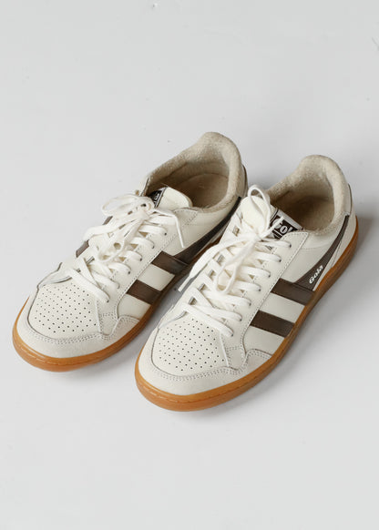 Ivory and brown Gola Eagle '86 sneakers with perforated toes, white laces, and gum soles on white background.
