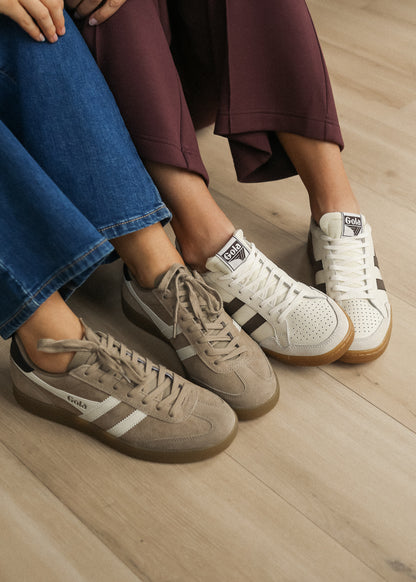 Cappuccino Gola Viper sneakers with ivory stripes and gum soles styled alongside ivory Gola sneakers.