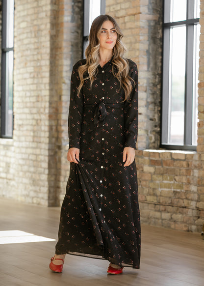 Black floral button down maxi dress with long sleeves and a matching waist tie, styled with red Mary Jane flats.