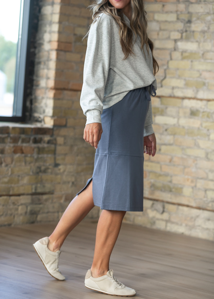 Side view of the Gracie Dusty Blue Midi Sweatshirt Skirt showing the modest midi length and back slit for movement