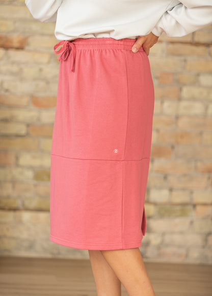 Side view of mulberry sweatshirt midi skirt showing its A-line movement and midi length.