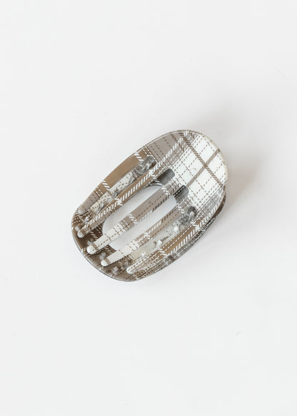 Gray plaid oval claw clip with open center design and neutral plaid pattern on a white background.