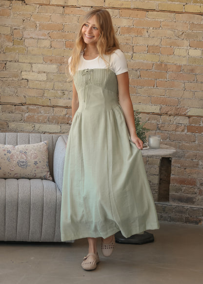 Mineral green Heartloom maxi dress with pintuck bodice and front tie styled over a fitted white tee.