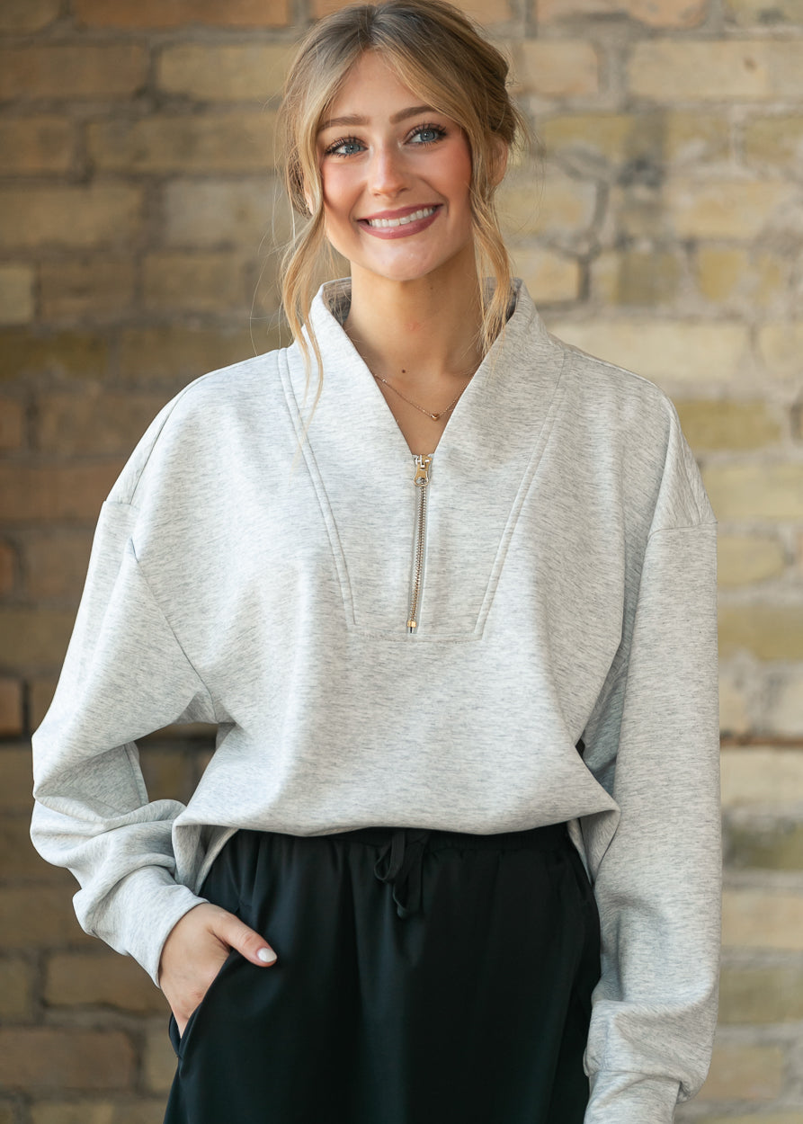 Front view of the heather gray quarter zip sweatshirt highlighting the notched collar and zip placket.