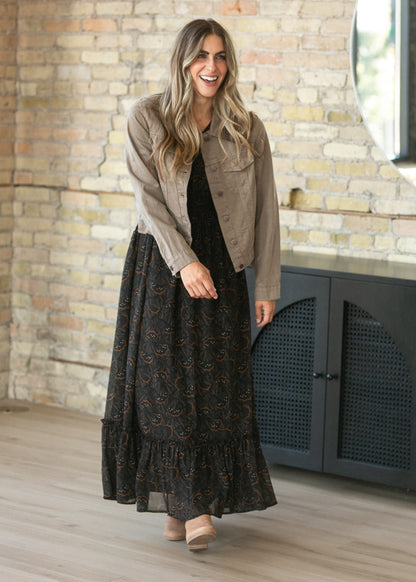Black floral leaf maxi dress with modest V-neck, flutter sleeves, smocked waist, and ankle-length hem.
