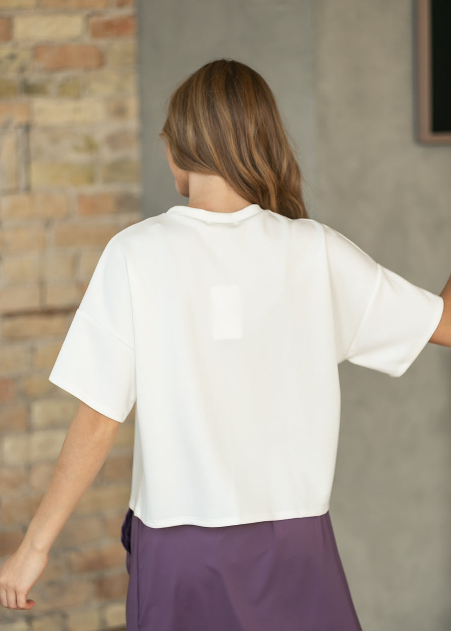 Back of ivory crew neck scuba top showing the loose fit and clean straight hem.
