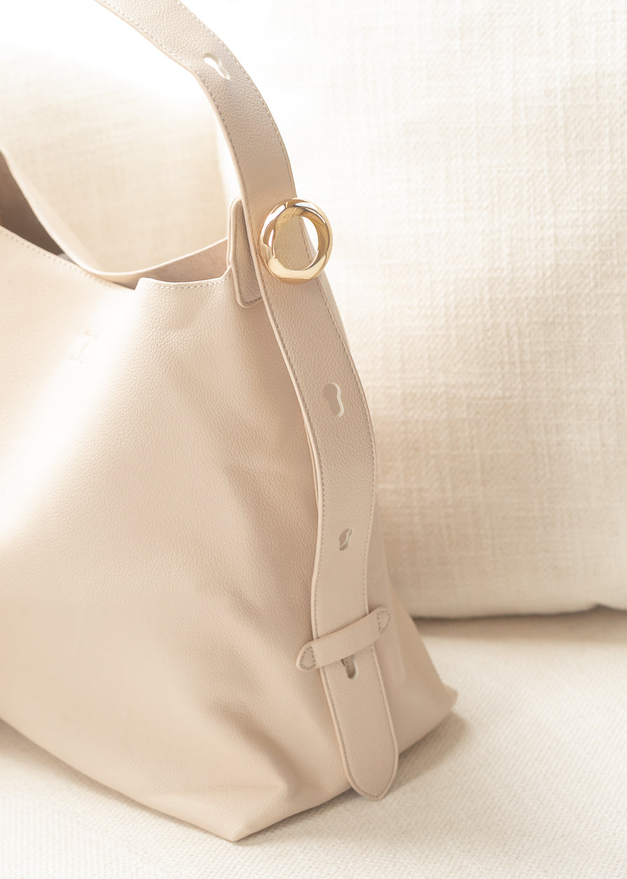 Removable ivory zip pouch with gold-tone zipper included inside tote bag.