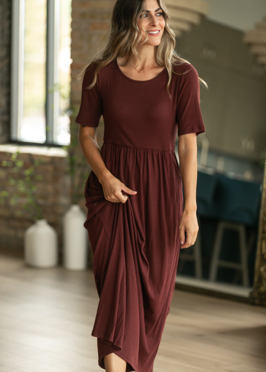 Cranberry maxi dress with round neckline, short sleeves, and softly gathered waist.