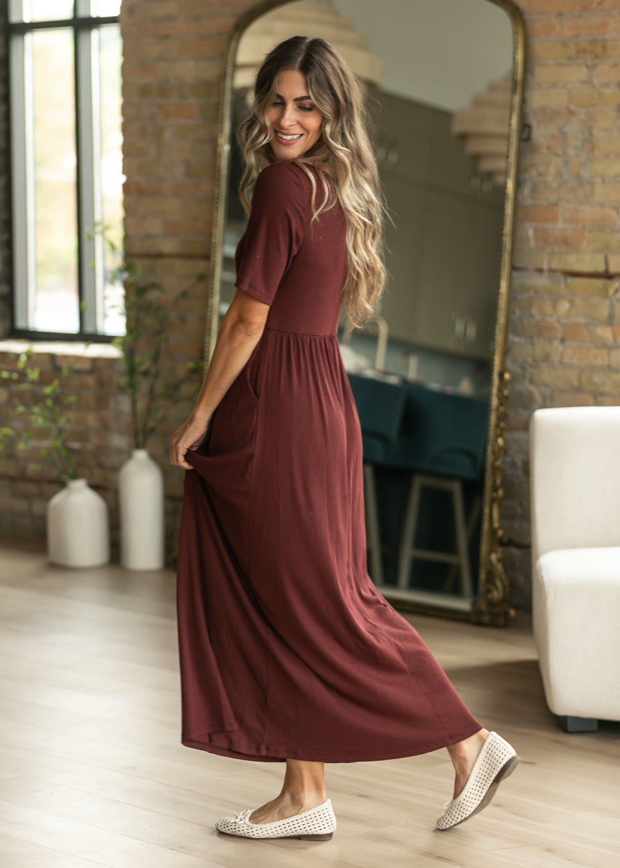 Jasmine cranberry maxi dress showing its semi-fitted shape and full maxi length.