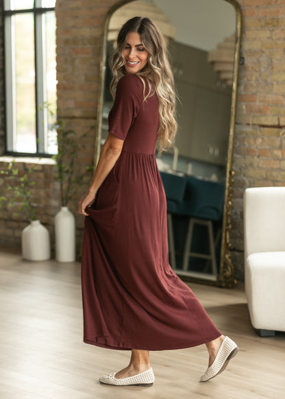 Jasmine cranberry maxi dress showing its semi-fitted shape and full maxi length.