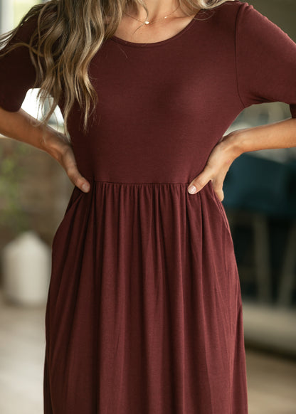 Cranberry ribbed maxi dress with stretchy gathered waist and flowing skirt.