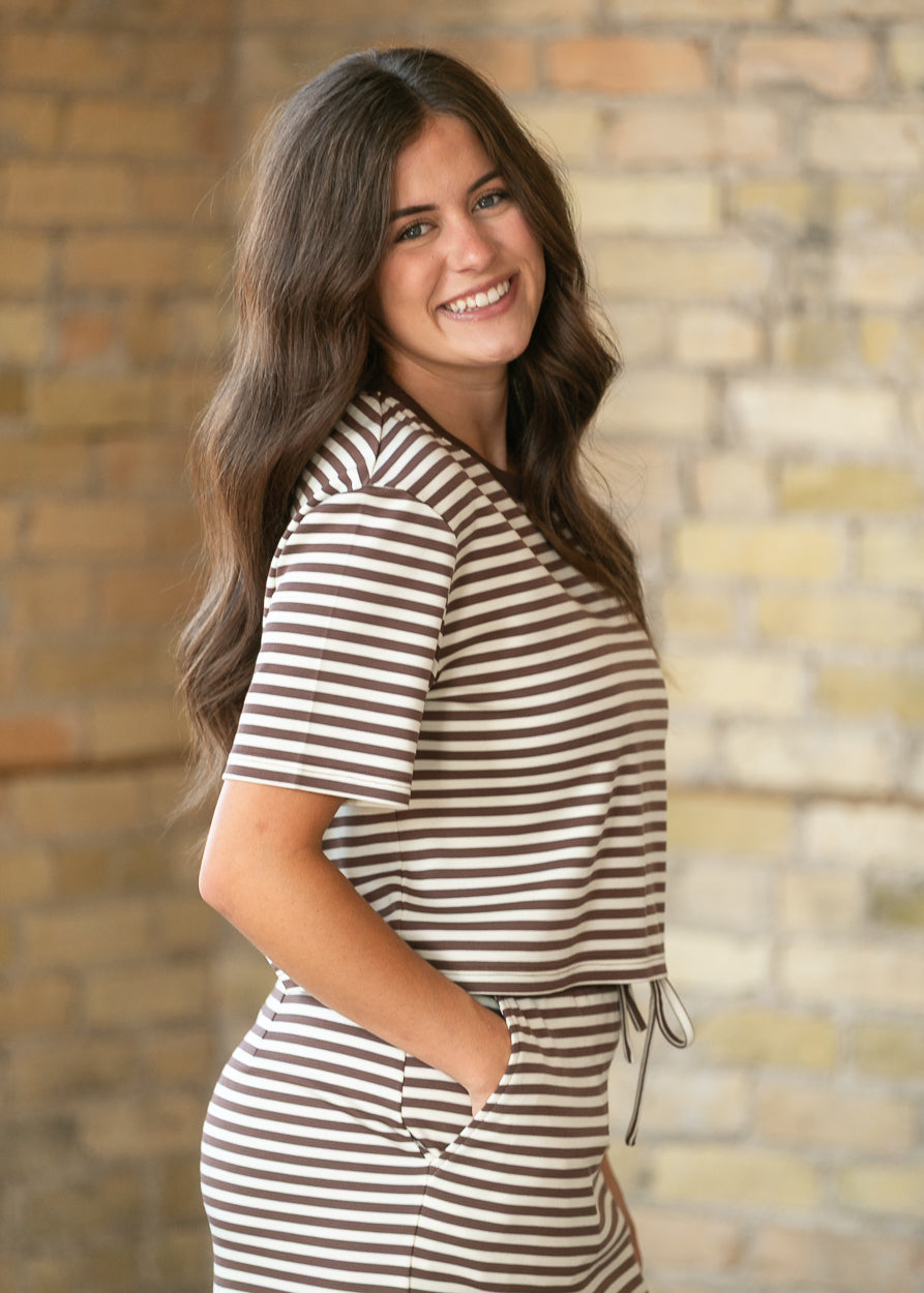 Side view of chocolate stripe boxy tee showing the loose fit and above-the-hip length.