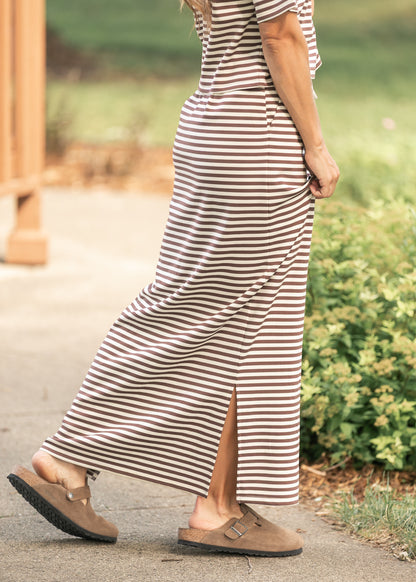 Close-up of chocolate stripe knit maxi skirt showing side slit and soft drape.
