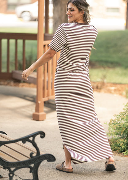 Back of chocolate stripe maxi skirt showing the straight silhouette and side slit detail.