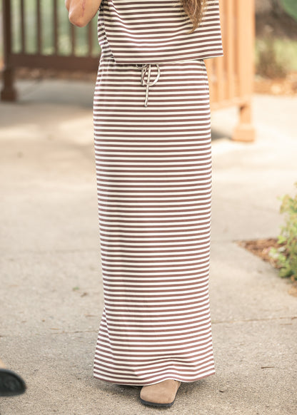 Front of chocolate stripe knit maxi skirt showing its full-length hem and drawstring waist.