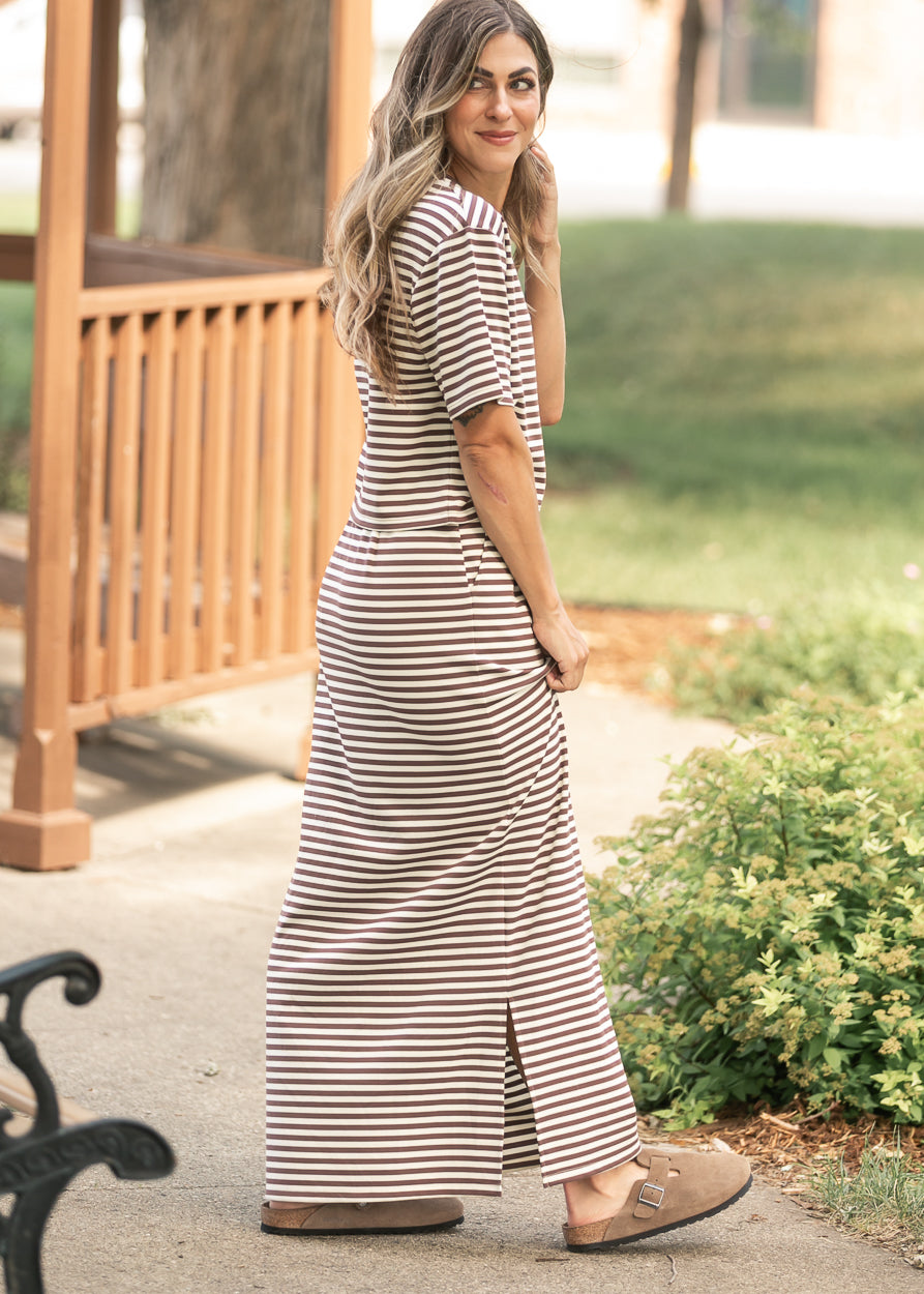 Chocolate stripe maxi skirt styled outdoors with matching short sleeve striped tee and neutral clogs.