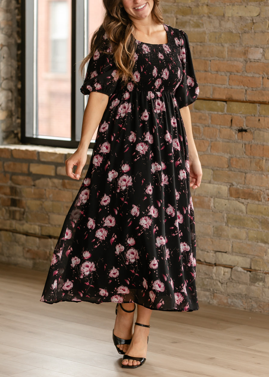 Black and pink floral maxi dress with a flowing skirt and feminine square neckline.