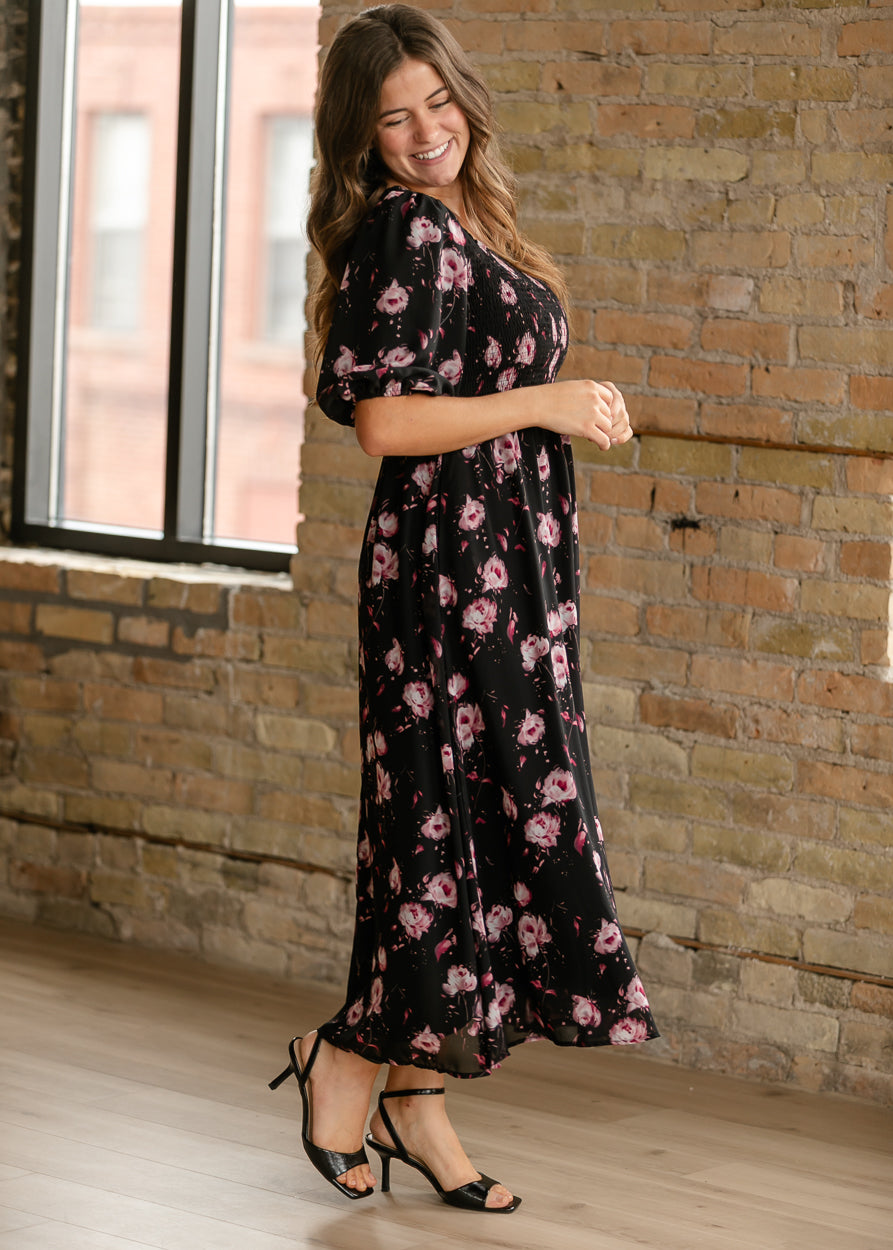 Pink floral maxi dress with short puff sleeves and a flowing fully lined silhouette.