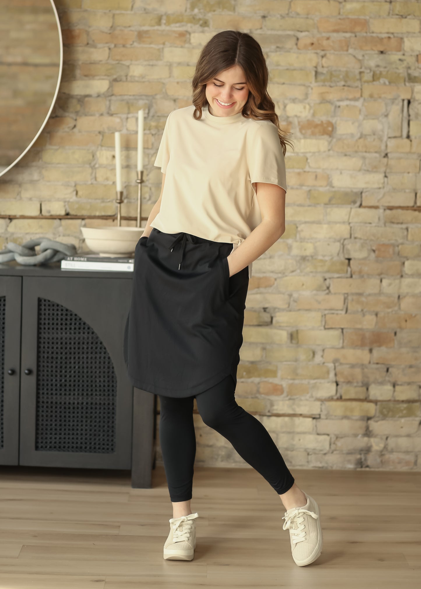 Black Kenedi athletic skirt with leggings, drawstring waist, and pockets styled for everyday movement.