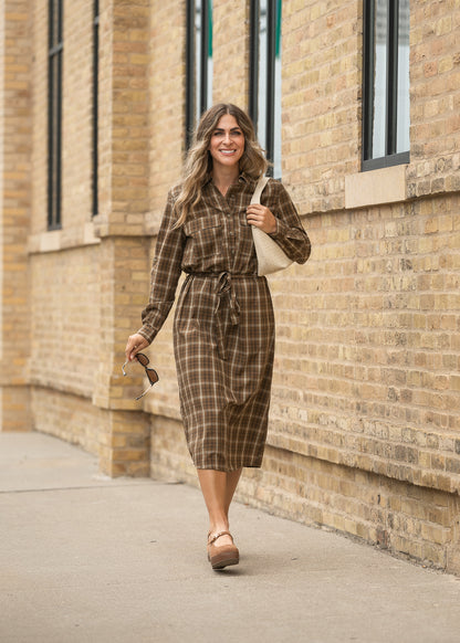 Kimberly brown plaid midi dress with long sleeves, button front, and tie waist styled with neutral flats.