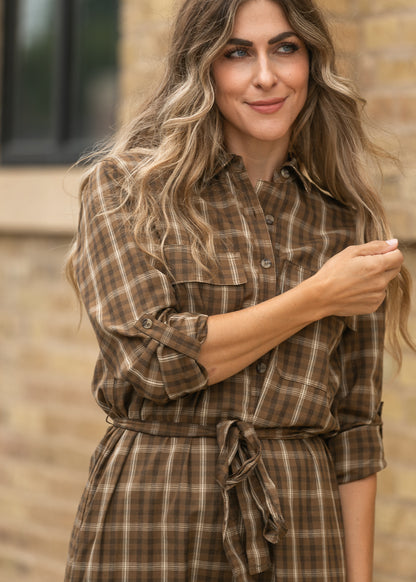 Brown plaid long sleeve midi dress showing the flowing skirt and waist tie.