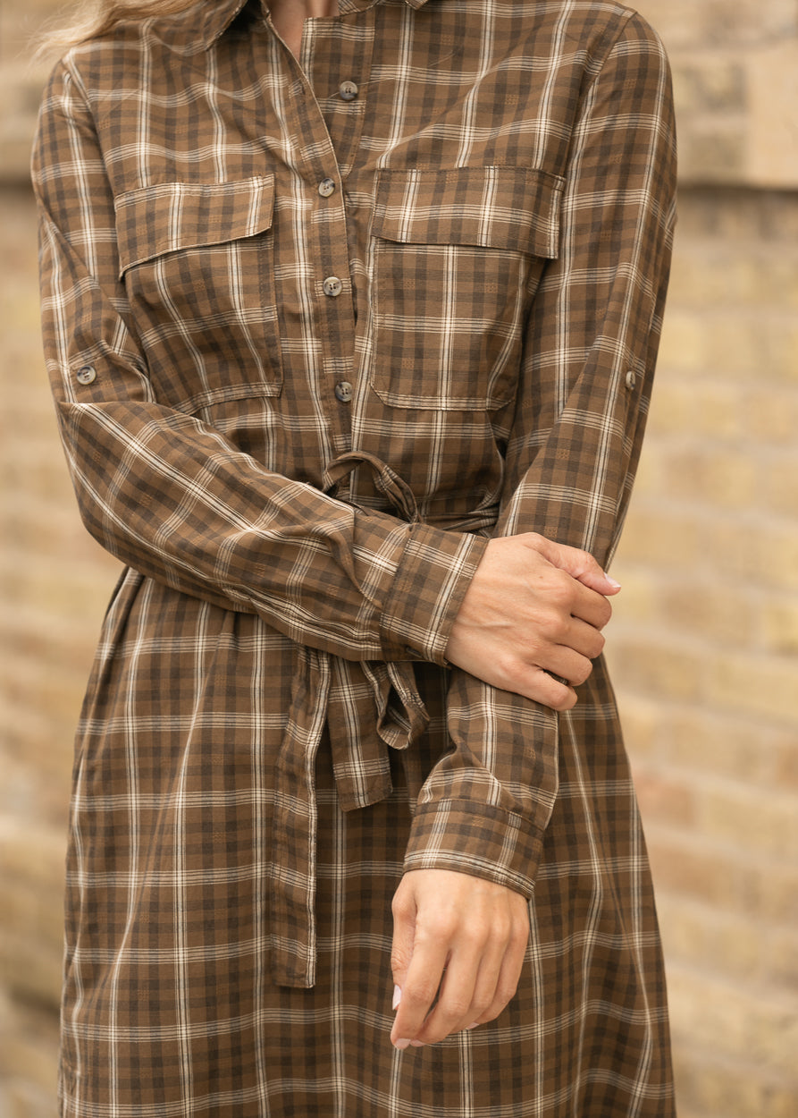 Brown plaid midi dress showing the long sleeve detail and gathered waist.