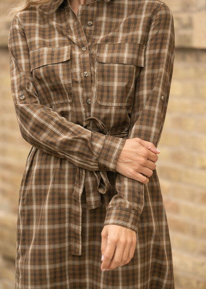 Brown plaid midi dress showing the long sleeve detail and gathered waist.