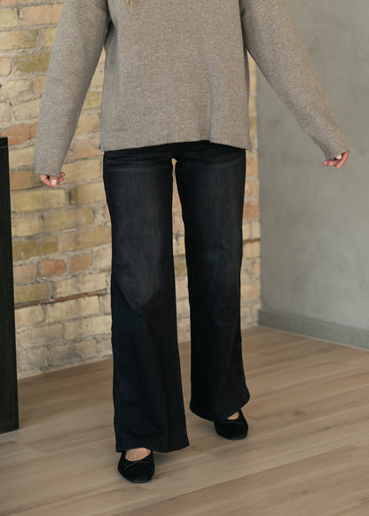 Dark black Jodi straight leg jeans styled with a relaxed taupe sweater for an everyday look.