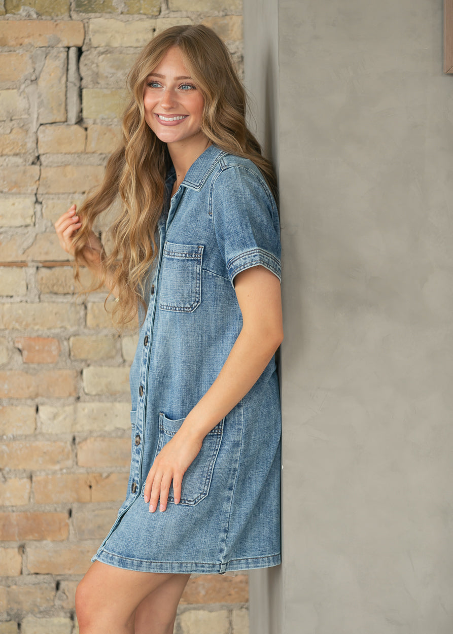 Side view of stretchy denim midi dress with functional pockets.
