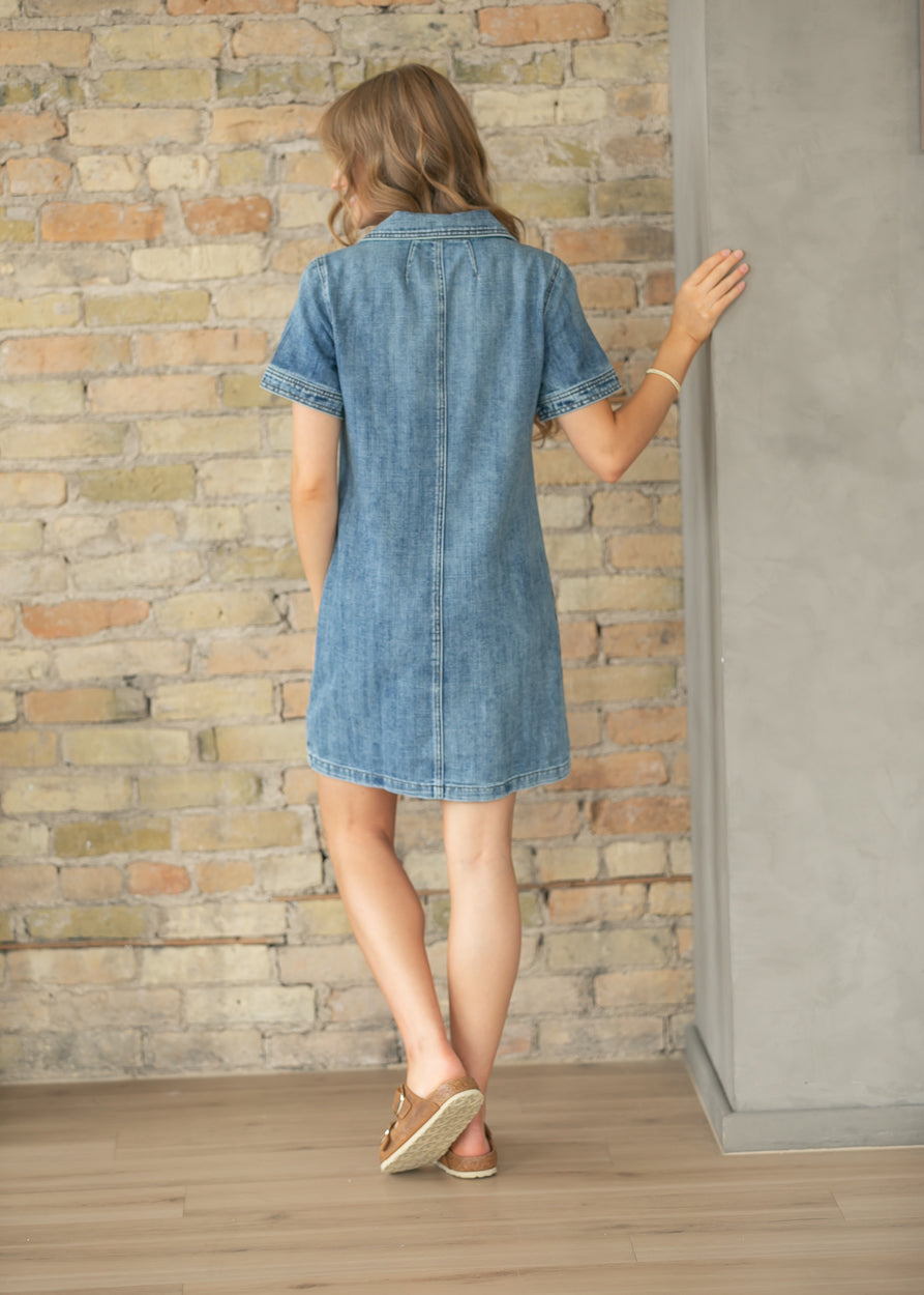Back view of medium wash denim midi dress with short sleeves.
