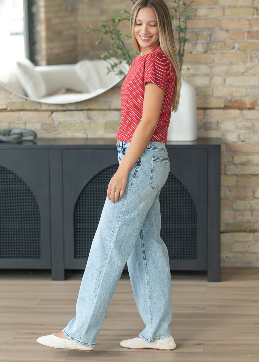 Kut From the Kloth Selena light wash jeans paired with a fitted red printed tee.