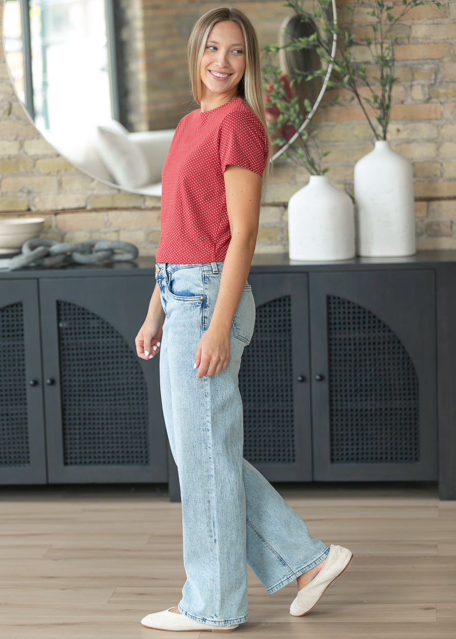 Side view of light wash baggy low rise straight leg jeans with relaxed silhouette.