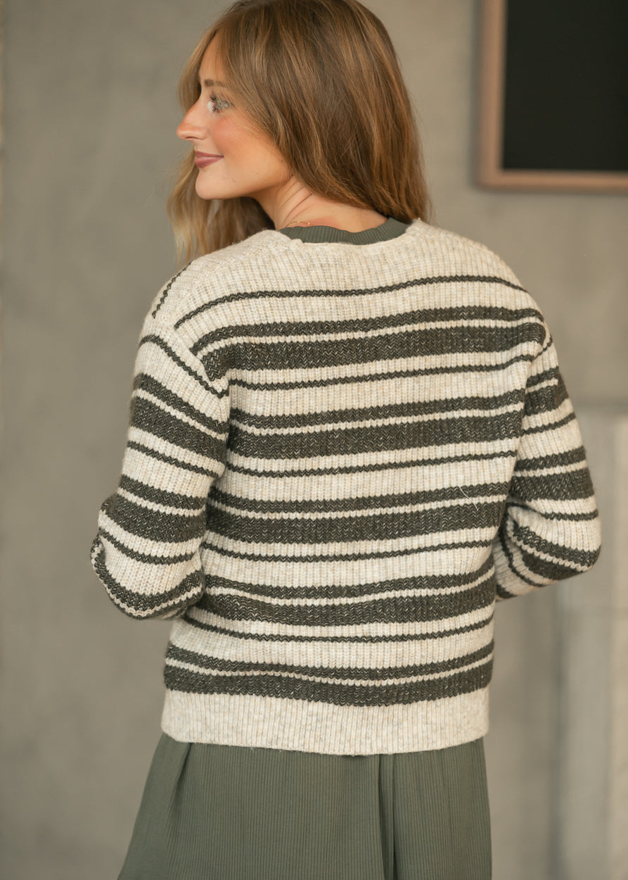 Back of cream and green striped knit cardigan showing the relaxed fit and below-the-hip length.