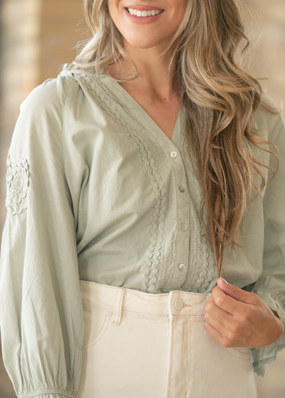 Sage woven top with feminine ruffle cuff accents