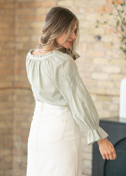 Feminine woven blouse with ruffle sleeve accents