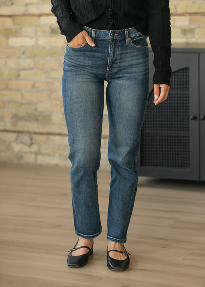 Dark wash slim jeans showing the fitted slim leg and just-above-the-ankle length.