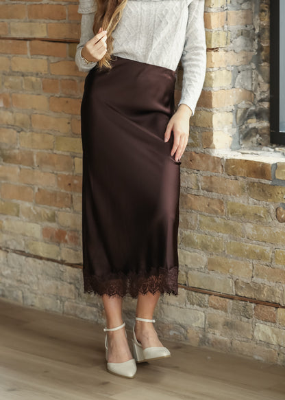 Chocolate brown satin midi skirt paired with a cream cable knit sweater