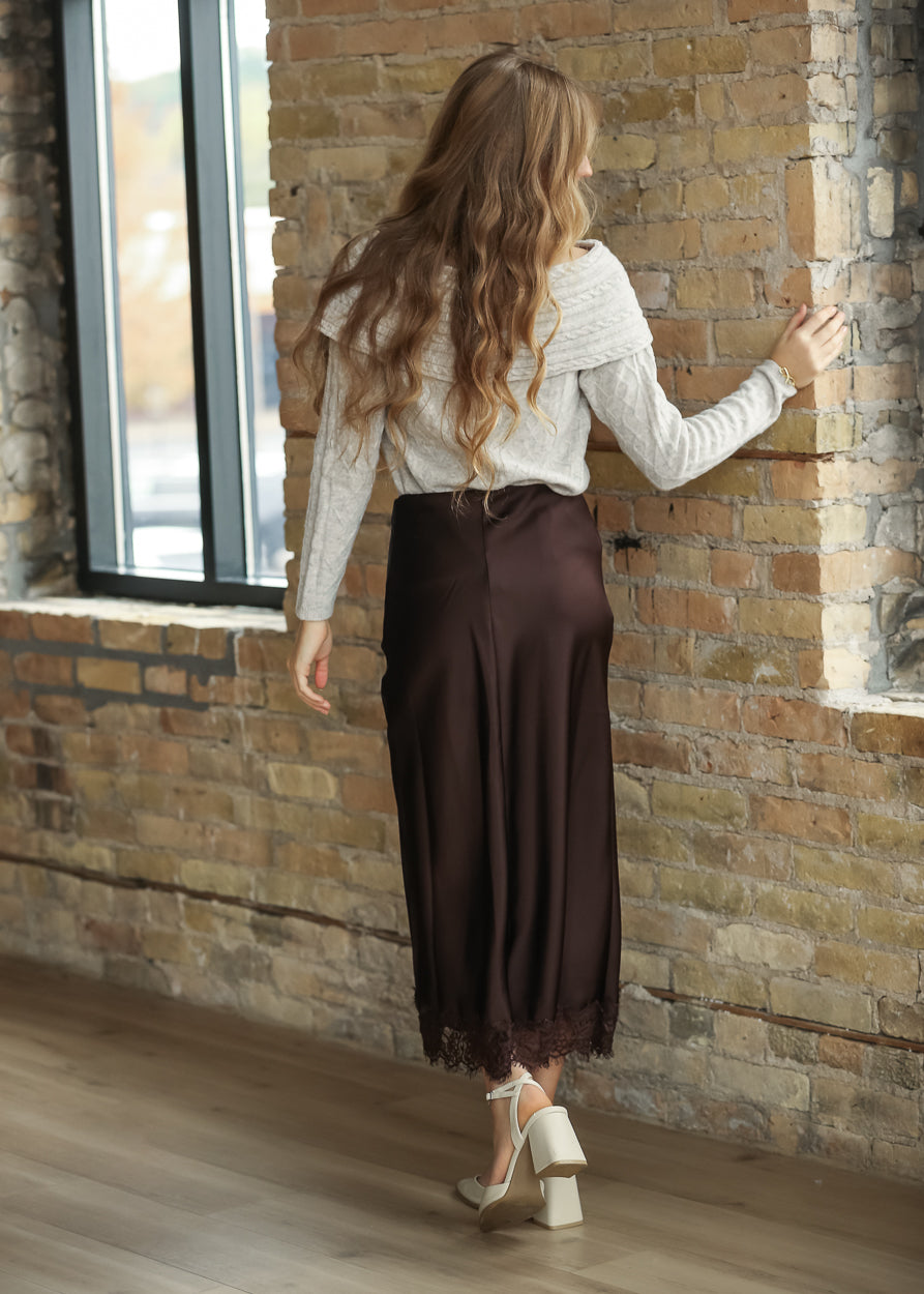 Back view of chocolate brown satin midi skirt with delicate lace-trim hem
