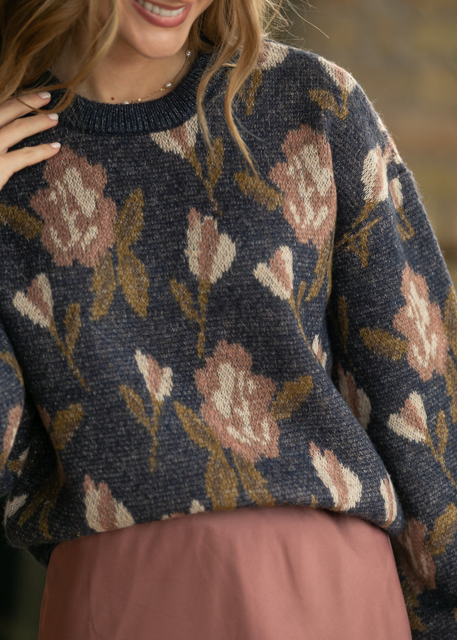 Navy floral long sleeve sweater with dusty rose and cream flowers, close-up of knit texture and ribbed crew neck.