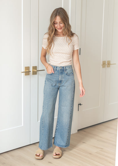 Front view of barrel leg denim jeans in a light medium wash
