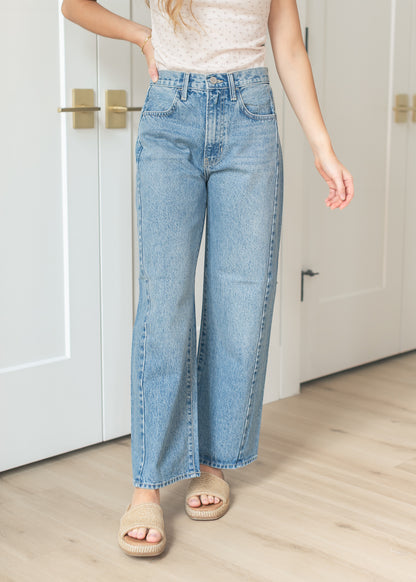 Medium wash barrel jeans styled with a fitted ribbed short sleeve top
