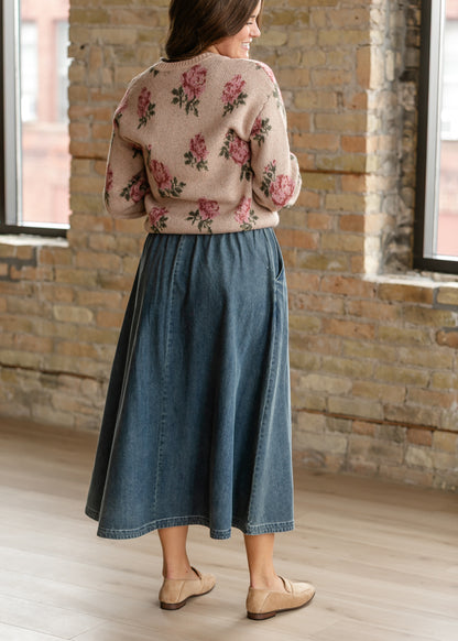 Lightweight denim midi skirt styled with floral sweater and neutral loafers.
