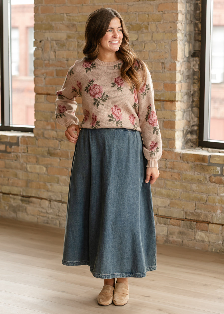 Sand floral Vincent sweater with dropped shoulders and ribbed cuffs, tucked into a denim midi skirt.