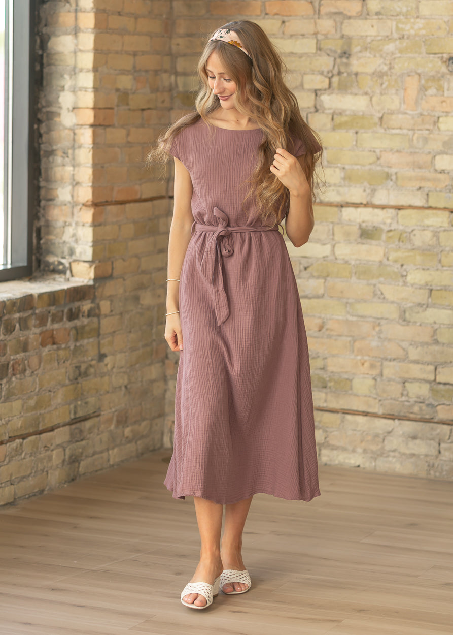 Blush floral satin square scarf worn as a headband with a textured mauve dress.
